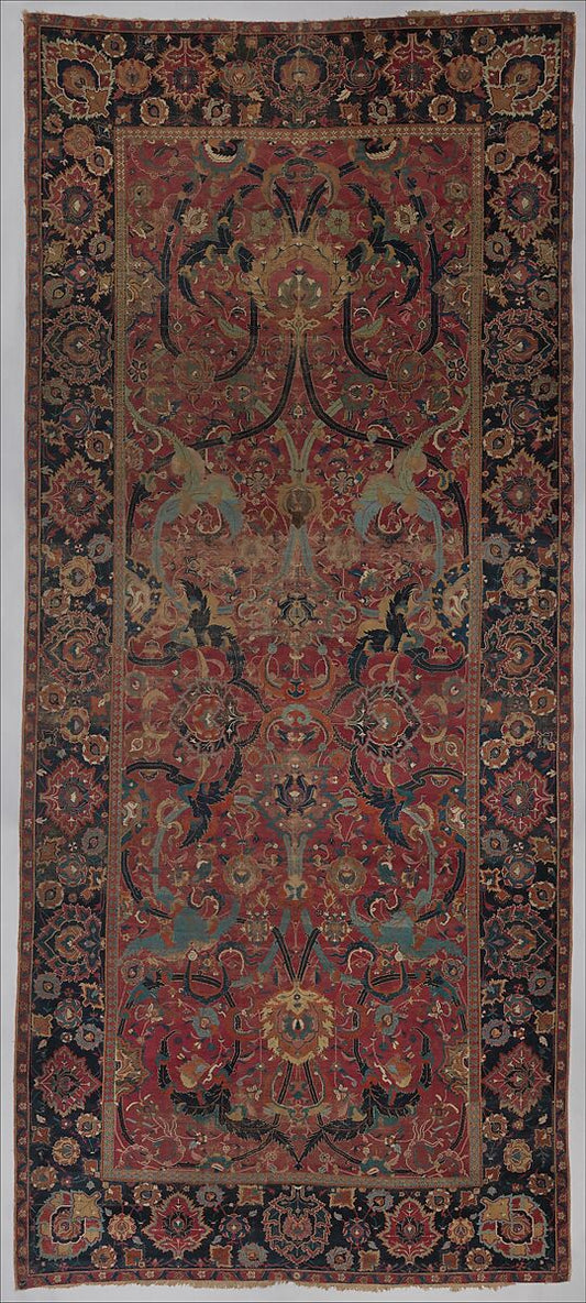 Seventeenth-century Iranian floral arabesque carpet with blue scrolling bands, rosettes, leaves, and palmettes